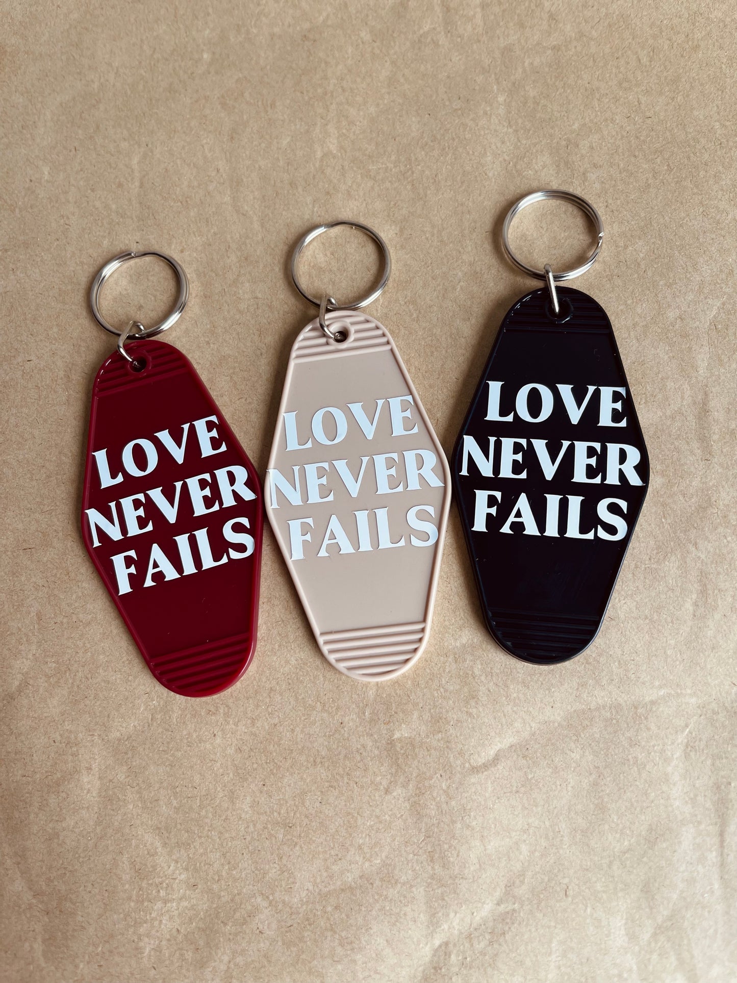 LOVE NEVER FAILS KEYCHAIN